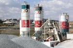 The cement maker said the earnings drop was due mainly to financing costs of the R2bn it was forced to raise in June to redeem bonds after its credit rating was cut to junk status.