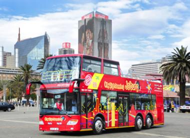 A City Sightseeing bus drives through Johannesburg offering locals and tourist alike the chance to explore the vibrant city..