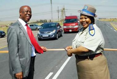 Mpumalanga Public Works, Roads and Transport MEC Dikeledi Mahlangu, on right, and department head Mathew Mohlasedi cut the ribbon during the official opening of a new road known as the P132/1 between Kriel and Matla outside Witbank.