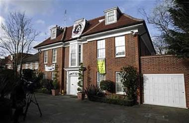 A banner hangs from a house, occupied by squatters, and thought to belong to Saif al-Islam Gaddafi, one of the sons of Libyan leader Muammar Gaddafi, in north London March 10, 2011. Credit: Reuters/Luke MacGregor