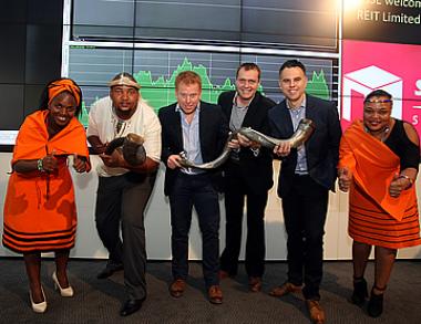 Gavin Lucas, CEO of Stor-Age Property REIT (3rd from Left) prepares to sound the kudu horn at the JSE listing event.