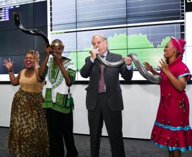 Seen on Acsion Limited JSE listing: Kiriakos Anastasiadis CEO and Founder of Acsion Limited celebrating with entertainers after blowing the ceremonial kudu horn to mark the company’s listing.
